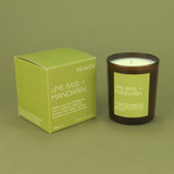 Lime, Basil & Mandarin 20cl amber glass scented candle from the Modern Heritage collection, shown beside its zesty green gift box.
