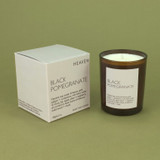 Black Pomegranate 20cl amber glass scented candle from the Modern Heritage collection, shown beside its ivory gift box.