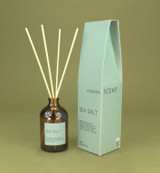 Sea Salt 100ml amber apothecary glass reed diffuser from the Modern Heritage collection, shown with natural rattan reeds and its sea foam blue gift box.
