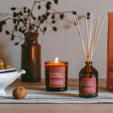 Festive Nutmeg & Cinnamon 20cl amber glass scented Christmas candle from the Modern Heritage collection, shown beside its spice coloured gift box.