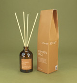 Pumpkin Spice 100ml amber apothecary glass Christmas reed diffuser from the Modern Heritage collection, shown with natural rattan reeds and its spice coloured box gift box.