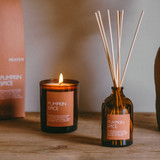 Pumpkin Spice 20cl amber glass scented Christmas candle from the Modern Heritage collection, shown beside its spice coloured gift box.