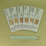 Green botanical incense sticks displayed in their green botanical card packs, showcasing the handmade British finish.