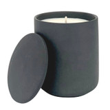 Hand-poured luxury scented candle in a modern graphite black ceramic pot with glowing flame