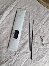 Black opium artisan incense sticks displayed next to their pastel heritage card pack, showcasing the handmade British finish.