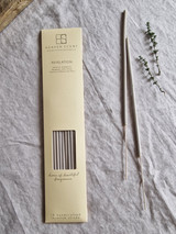 Revelation artisan incense sticks displayed next to their pastel heritage card pack, showcasing the handmade British finish.