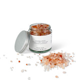Close-up of a 140g clear glass pharmacy jar filled with pink Himalayan bath salts, ready for a calming soak.