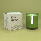20cl natural soy wax Sea Moss scented candle in a beautiful green glass jar, next to its recycled presentation box.