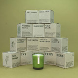 20cl natural soy wax Rosehip scented candle in a beautiful green glass jar, next to its recycled presentation box.