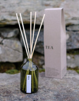 Heaven Scent Tea scented reed diffuser set, including the green glass bottle, rattan sticks, and a recycled gift box.