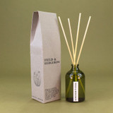 Heaven Scent Field & Hedgerow scented reed diffuser set, including the green glass bottle, rattan sticks and a recycled gift box.
