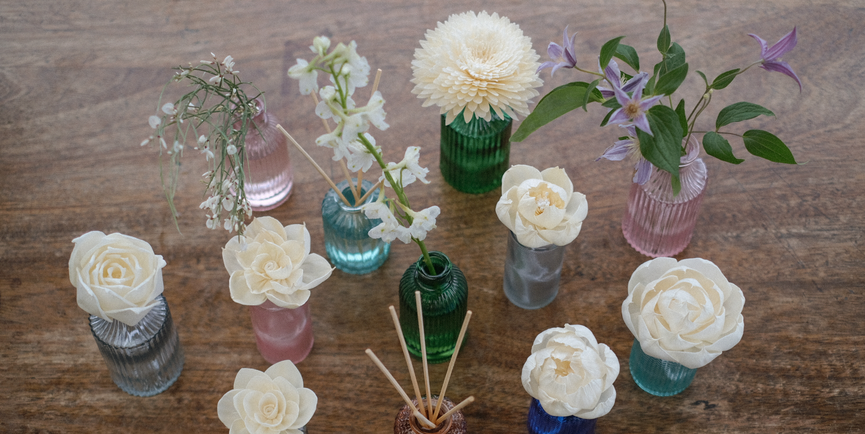 Heaven Scent's Coloured Glass bottles, with wild flowers, rattan reeds and sola paper flowers perfect for diffuser liquid and small posies