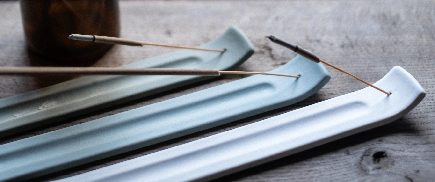 surface, holding burning incense sticks.