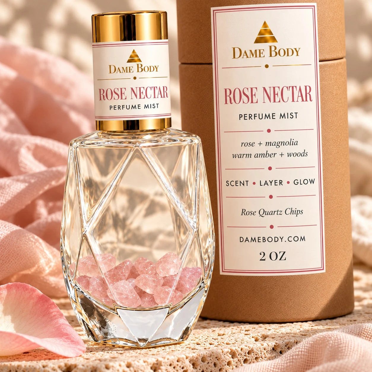 Close view of clear Rose Nectar perfume with pink rose quartz chips, gold cap and matching labeled kraft tube.