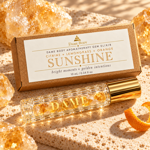 Sunshine Citrine aromatherapy roller and labeled kraft box in warm golden light.