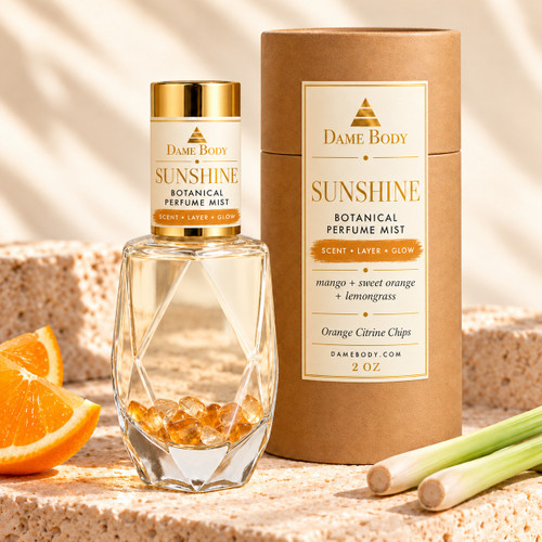 Sunshine Perfume, 2 oz, with clear liquid and orange citrine chips in faceted glass, gold cap, and kraft tube with matching mango-gold label brushstrokes.