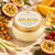 Sunshine Body Butter with its yellow-and-gold Dame Body label among passion fruit, mango, rosehip, sea buckthorn and golden oil in warm editorial light.