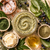 Soft green Juniper Aloe sea salt body scrub texture with botanical powders