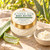 Juniper Aloe Body Butter beside cut aloe leaves and a scoop of creamy butter.