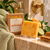Citrus Agave Soap Bar with African net sponge on a wet ivory shower ledge with bright citrus botanicals
