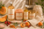Dame Body Cantaloupe body care collection with wash, polishing scrub, body oil, body butter, and exfoliating cloth.
