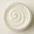 Open Jasmine Rose Body Butter showing its rich ivory creamy swirled texture.