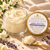 Open Jasmine Rose Body Butter showing its rich ivory texture beside the approved lavender-purple and gold labeled lid.