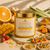 Dame Body Sunshine Polishing Body Scrub in a clear 12 oz jar with golden-orange scrub, styled with orange, mango, ginger, turmeric, rosehip, sea buckthorn, and golden botanicals.