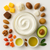 Open Unscented Body Butter with mango, avocado, nuts, seeds and bowls of oils.
