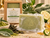 Serenity Green Tea Soap Bar with creamy lather, water droplets and fresh green botanical accents