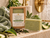 Serenity Green Tea Soap Bar with African net sponge on a wet ivory shower ledge with green tea and botanical accents