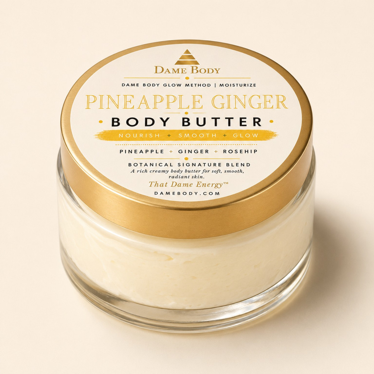 Pineapple Ginger Body Butter in a clear jar with its approved cream, yellow and gold lid label.