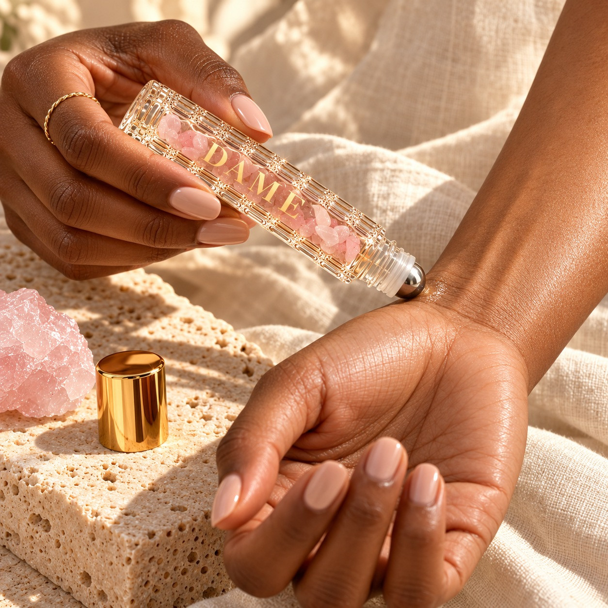 An adult woman lightly applies the Dame Nectar metal roller ball to clean inner-wrist skin.
