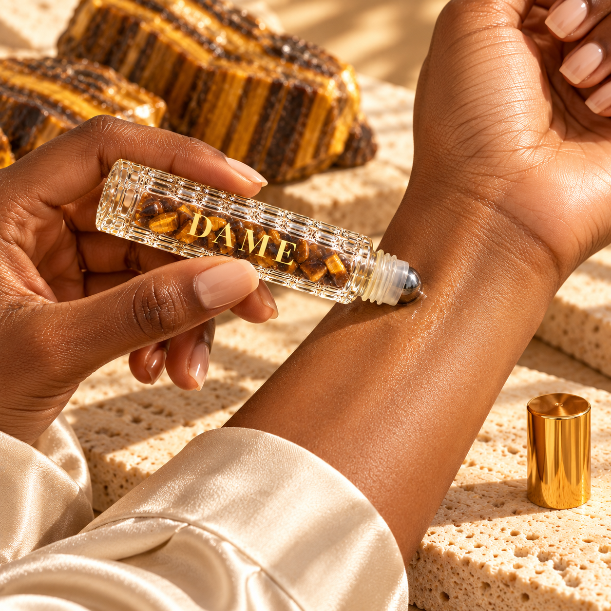 An adult woman lightly applies the Fearless Dame metal roller ball to her inner wrist.
