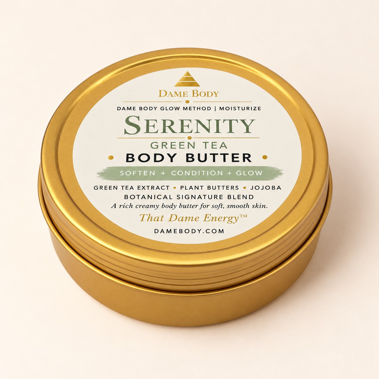 4oz Gold Tin Body Butter with the current Serenity Green Tea label, pale green accent and gold Dame Body mark.