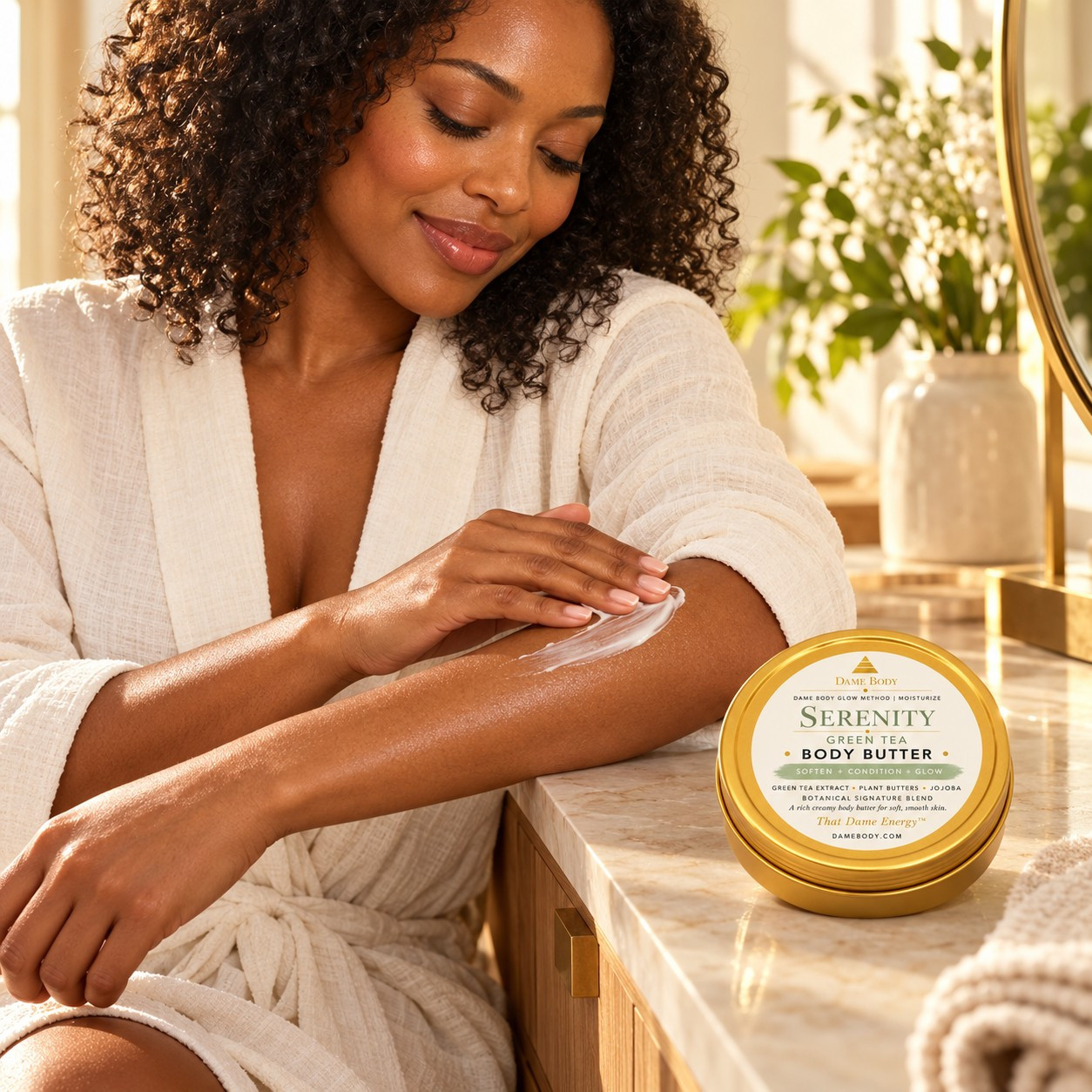 Black woman gently smoothing body butter on her forearm beside the current-label 4oz gold tin; Serenity Green Tea is shown.