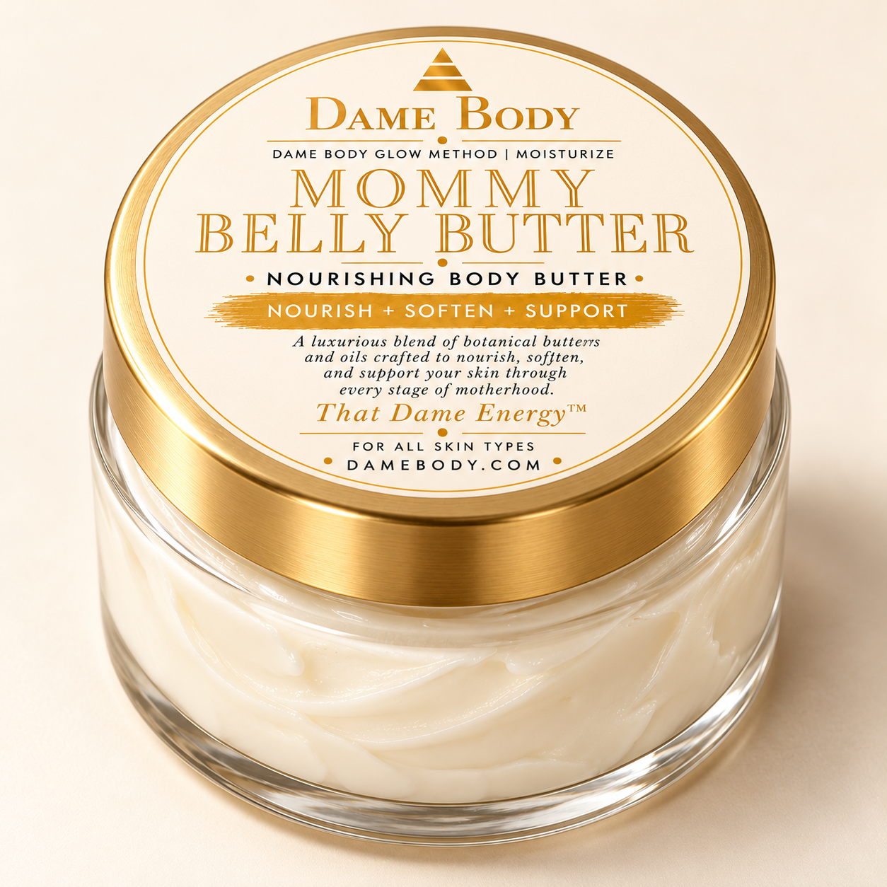 Mommy Belly + Body Butter in a clear glass jar with a gold lid and the approved warm gold/yellow circular label.