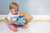 Finalist for the 2019 Progressive Preschool Awards in the ‘Best Infant Development’ category

6×6″ Taggies was born over a decade ago when a mom noticed her child’s fascination with satin tags. This idea blossomed into a world of treasured products.

Little ones are mesmerized by rubbing these soft, satin loops. Exploring Taggies textured tags can provide tactile stimulation that babies crave for development and have an amazing calming effect on little ones. Discover the secret too!

Taggies books are winning awards for their combination of stimulation (squeaker and crinkle paper inside) and soothing features (eight Taggies ribbons and textured fabric covers). Each book tells a short, sweet story in eight pages with Velcro® closure.

Begin each day with a long, slow hug. In the Baby market, sloths are hot! Molasses is our “cute” version of a realistic sloth. Molasses Sloth is a truly gender neutral buddy. Naturally neutral color palette. Sloth is incredibly adorable, with a captivating face, and tags all over.

– 6×6″ Soft book featuring Taggies Molasses Sloth in a fun, calming, short bedtime story
– 2-dimensional book with 3-dimensional details
– On-trend greenery
– Fabric applique cover
– All-emboridered details
– Lots of Taggies ribbons
– 8 pages
– Velcro® closure
– Crinkle paper and squeaker inside
– Coordinates with the Molasses Sloth collection
– Machine wash, air dry