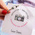 Flash of brilliance? It’s yours in a snap with this striking Camera Bangle featuring a stunning crystal “lens” with a black enamel coloring. Get ready for your close-up.

Easy hook and catch closure
Oval shape ensures proper fit
Silver tone finish
Includes an essence card
Made in the USA