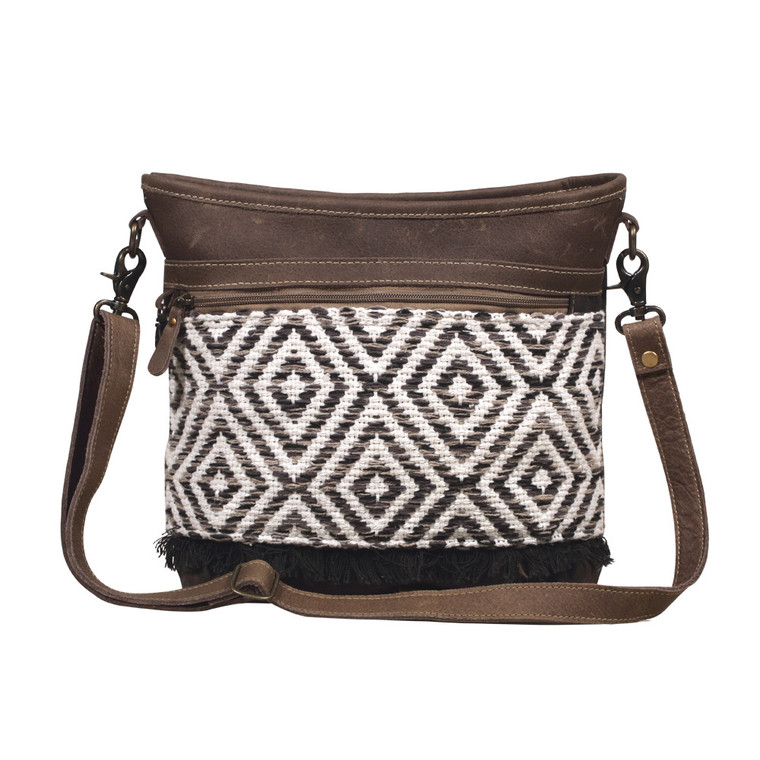 A shoulder bag with a fresh geometrical pattern, suave leather patches and an arched design. Created with roomy inner pockets and reinforced with a durable military tent material backing.