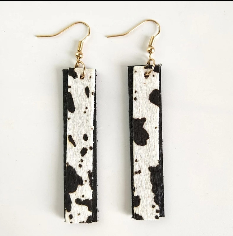 Trendy cow printer leather dangle earring. Adds a little style to the most basic outfit.