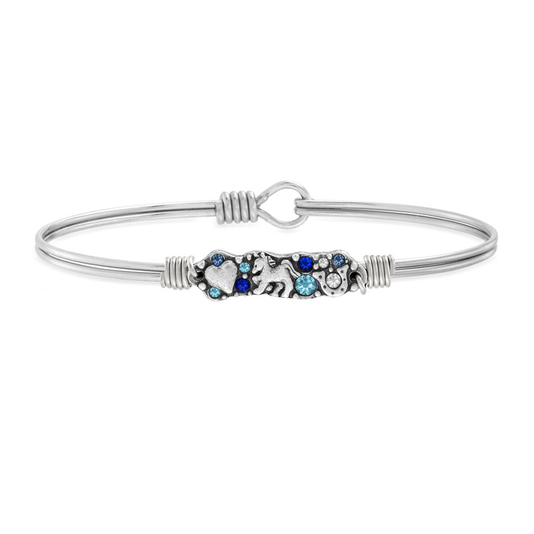 Clop to it. Our bestselling medley collection just took on a gorgeous new equestrian spin. This horse-lovers’ bracelet is handmade with Swarovski® crystal touches and etched silver emblems of a horse, horseshoe and heart.

Handmade using artisan metals
Easy hook and catch closure

Oval shape ensures proper fit
Silver tone finish
Swarovski® crystals in Crystal, Aquamarine + Sapphire
Includes an essence card
Made in the USA