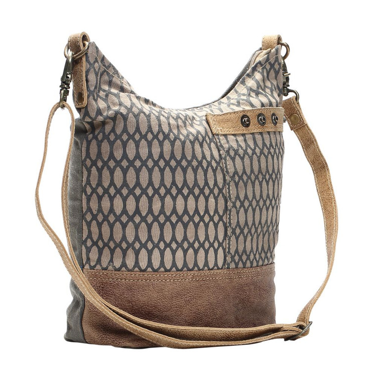 This Shoulder Bag has chic fashion pattern and make traveling in style easy! This bag features one front pocket and zippered top closure to secures items inside. Made of upcycled canvas and leather, this bag is durable adn stylish.