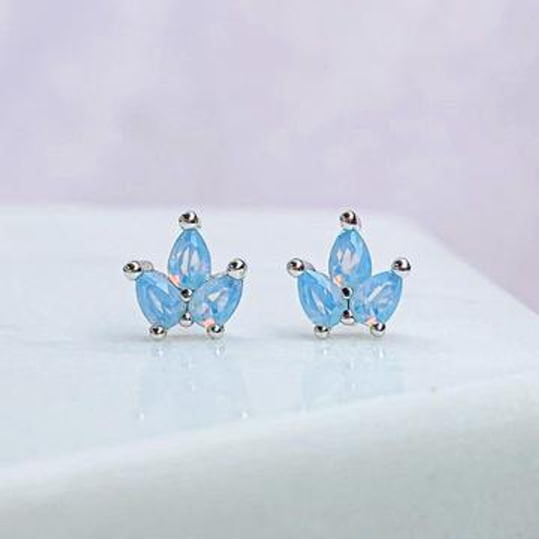 Three prong set pear shaped milky blue cubic zirconia stones come together in a cluster in these dainty, sterling silver stud earrings.

Three Prong Set Milky Blue Opal Pear Shaped Stones
Solid Sterling Silver
Nickel Free