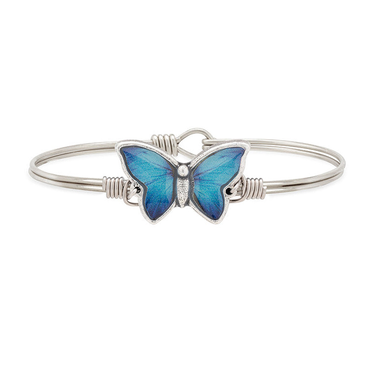 Change can be beautiful, even when it’s out of the blue. Our handcrafted Blue Morpho Butterfly Bracelet celebrates the significance of a blue butterfly in many cultures: conveying honor, joy, acceptance, exuberant energy and transformation, to name a few. Here, its distinctive pattern is vividly printed and encased within a handcrafted open-wing setting.
Handmade using artisan metals
Easy hook and catch closure
Oval shape ensures proper fit
Silver tone finish
Includes an essence card
Made in the USA