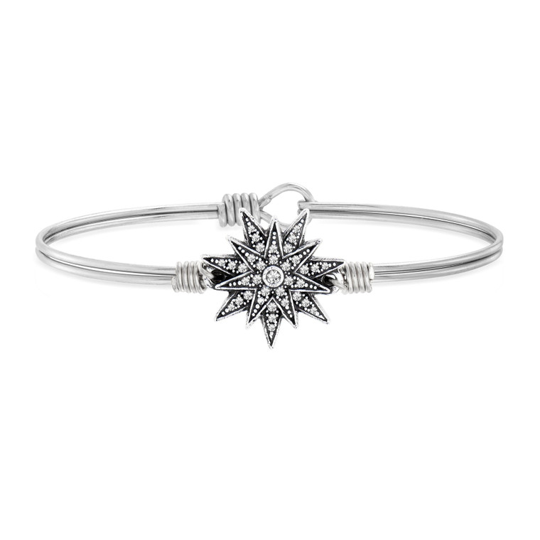 Reflect on what’s eternal in the face of life’s crossroad moments. Our North Star Bracelet is a fixture in any collection, thanks to its timeless 14-point design illuminated with delicate crystals.

Easy hook and catch closure
Oval shape ensures proper fit
Silver tone finish
Includes an essence card
Made in the USA