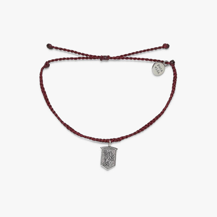 We’re not lion when we say the Gryffindor™ Crest Charm Bracelet is the most magical style around! Set on a merlot bitty braid band, this enchanting design features a dangling crest charm, with a Gryffindor™ lion etched on the front and “courage, determination, bravery” on the back. For every bracelet sold, Pura Vida will donate 5% of the purchase price to the World Literacy Foundation, with a maximum donation of $25,000. Your donations will help further the World Literacy Foundation’s mission to ensure that every child—regardless of geographic location—has the opportunity to acquire literacy skills and books to reach their full potential!