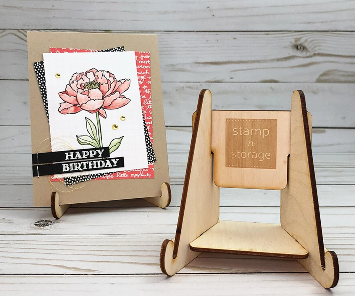 Handmade peony birthday card on a wooden Stamp-n-Storage card display stand, beside an empty stand
