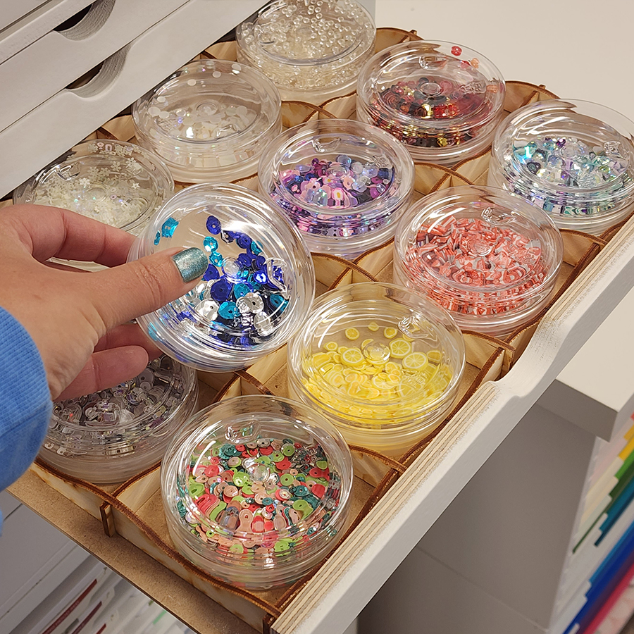 Hand picking up Stamp-n-Storage Crafty Storage Jars from grid in Drawer Cabinet