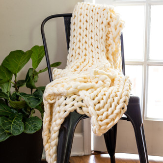 Ivory Cream Lush Chunky Knit Throw on chair